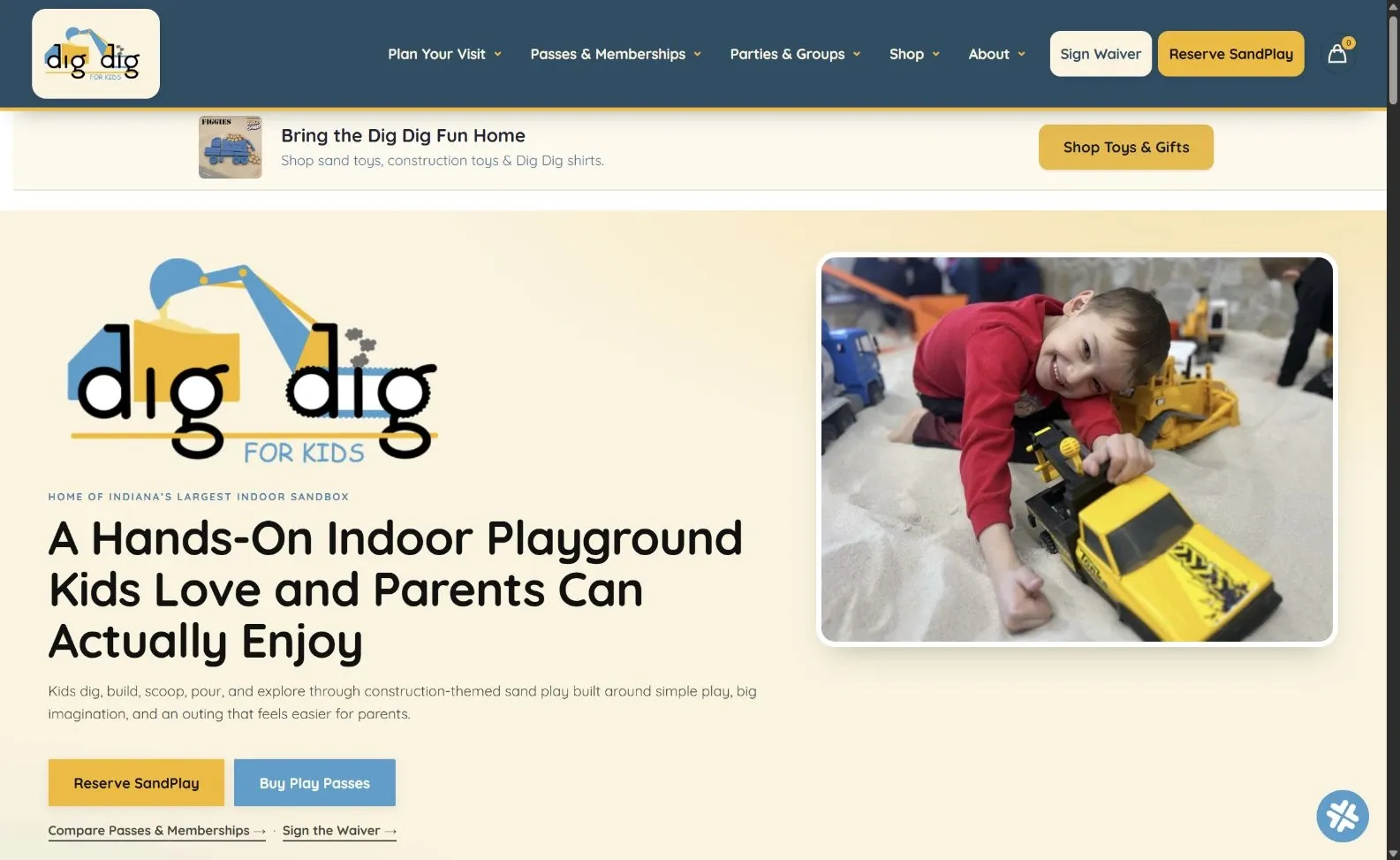 Dig Dig for Kids homepage with indoor playground messaging, visit navigation, play-pass links and a child playing in sand.